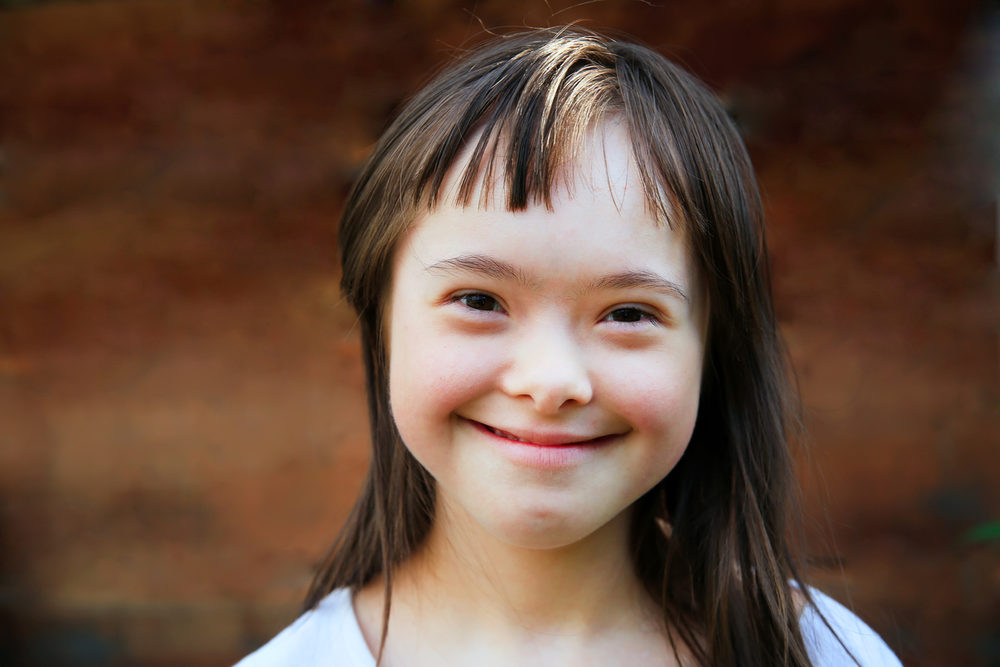 Smiling young girl with long brown hair